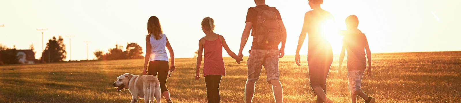 Family taking a walk at sunset.