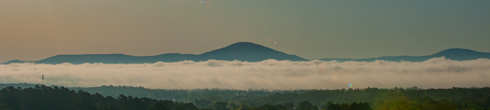 Large hill near Heavener, OK, surrounded by clouds.